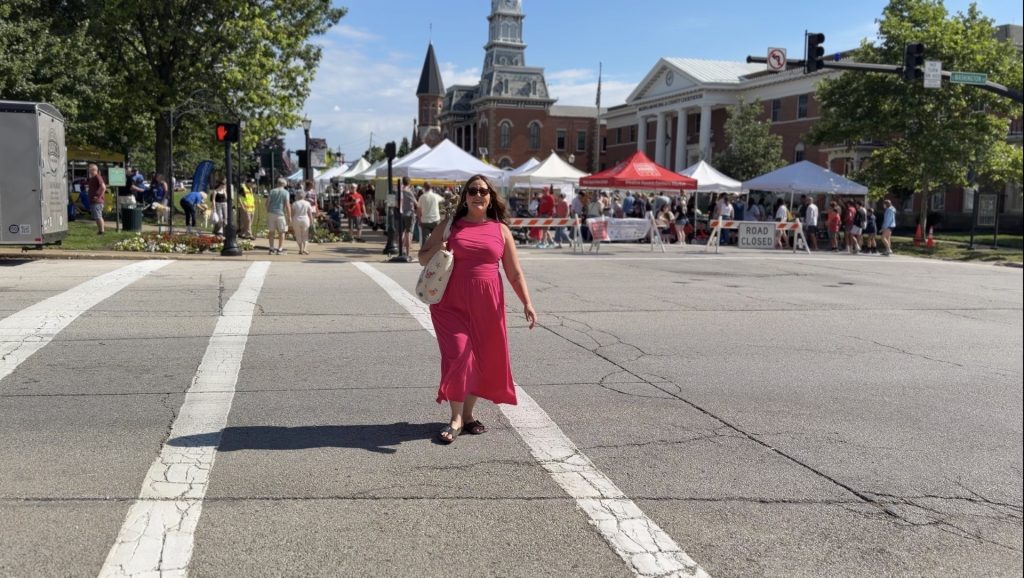 Traci Taylor crossing the street toward the farmers market on the historic square in Medina, Ohio