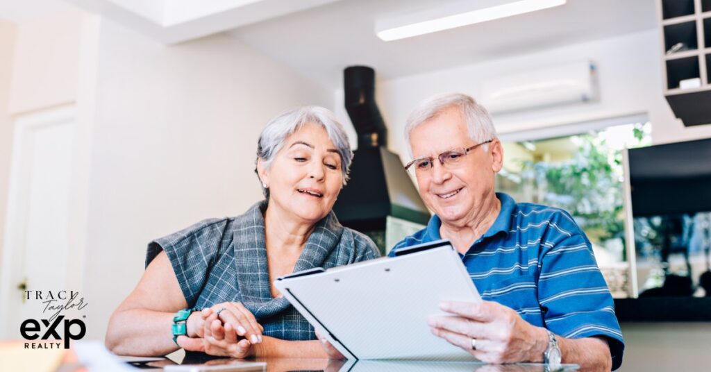 Couple sitting at kitchen table reviewing documents in family home